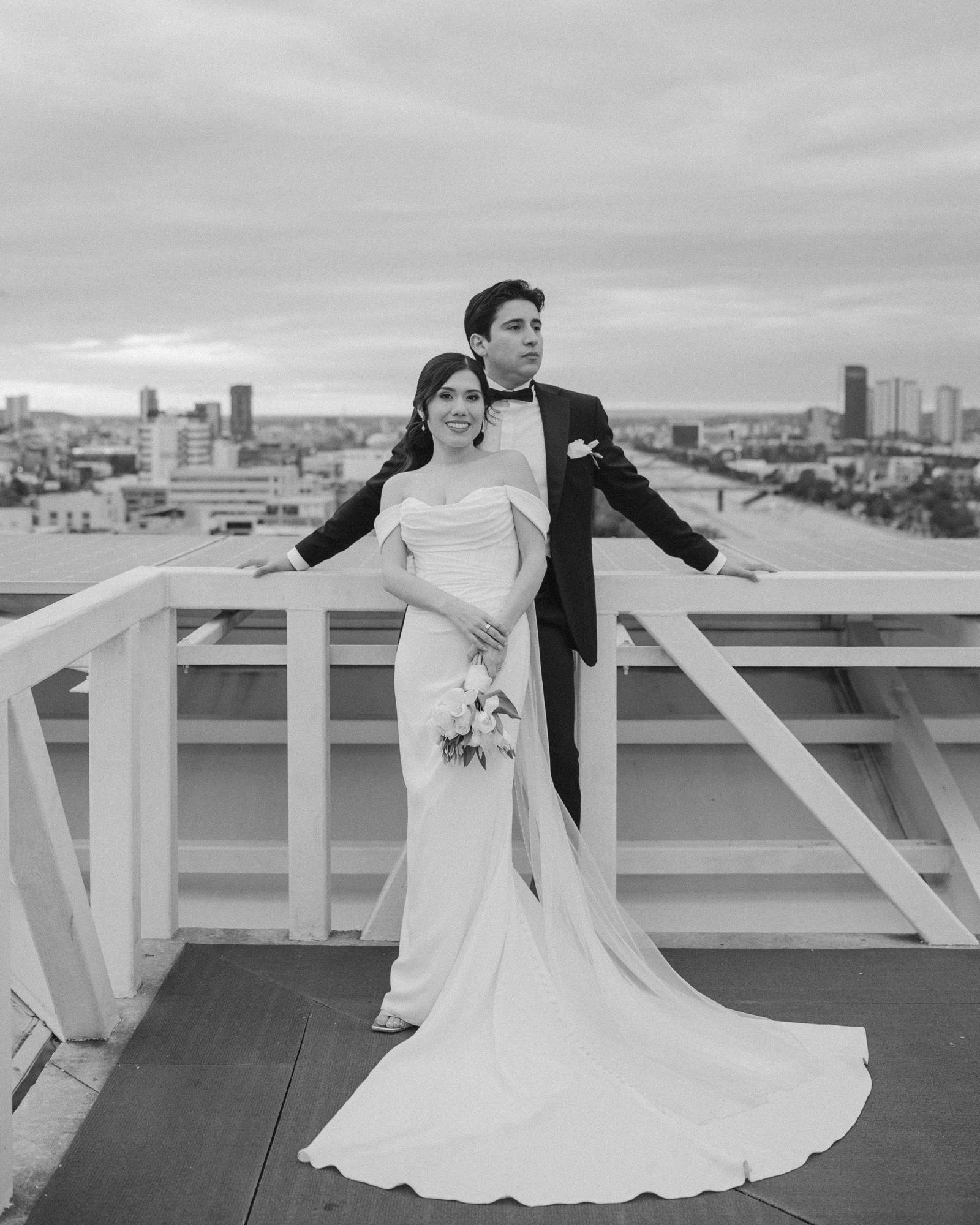 black and white wedding portrait on a rooftop at vía corporativo in tijuana, bride and groom with the city skyline, november 2025