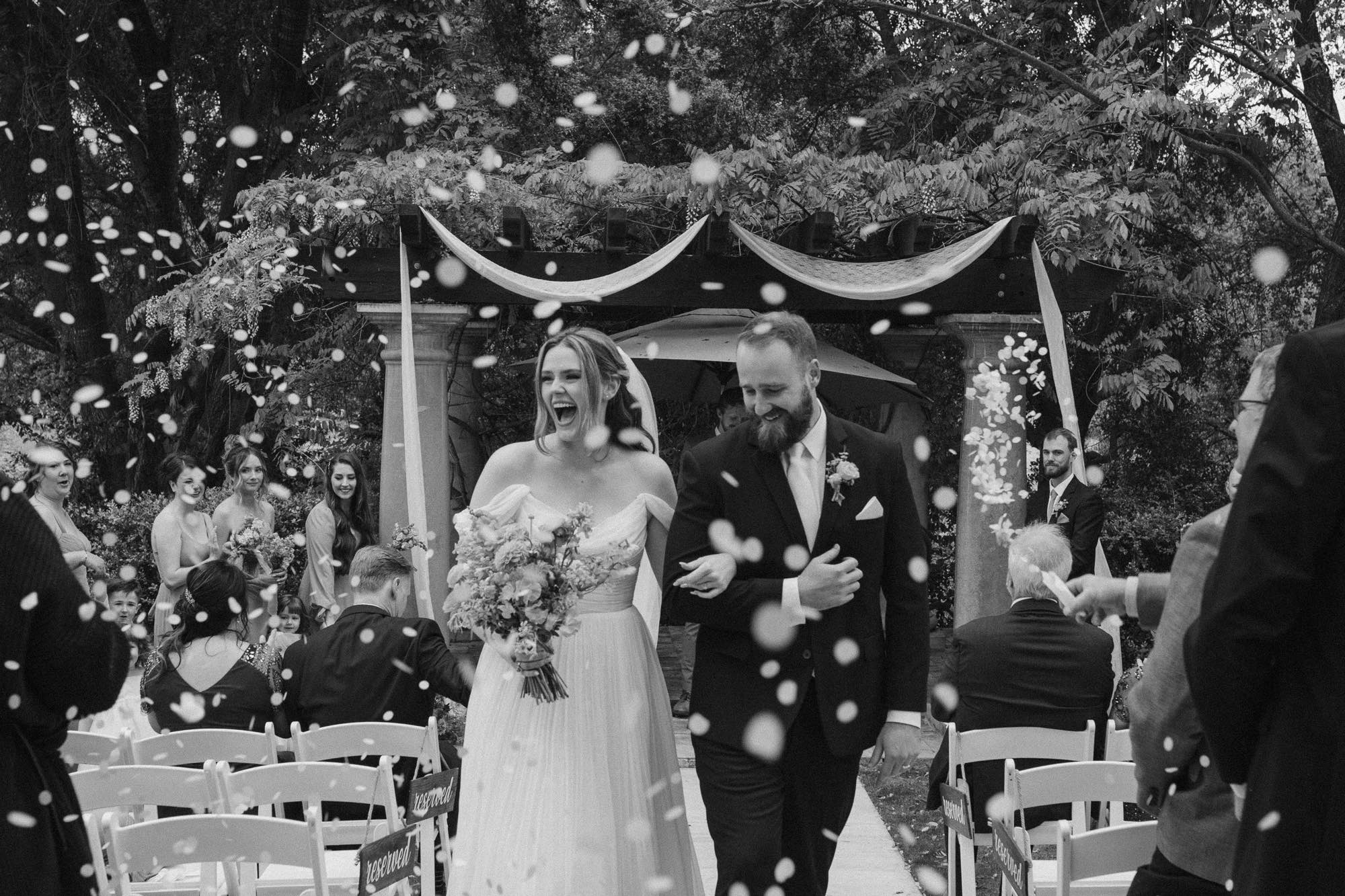 black and white wedding recessional at Willow Creek Events, Valley Center, San Diego, bride and groom walking through flower petals