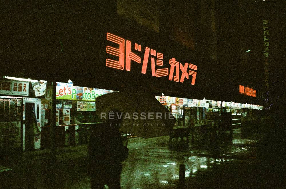 neon signs in the rain at night in shinjuku tokyo, citypop mood 35mm film photography